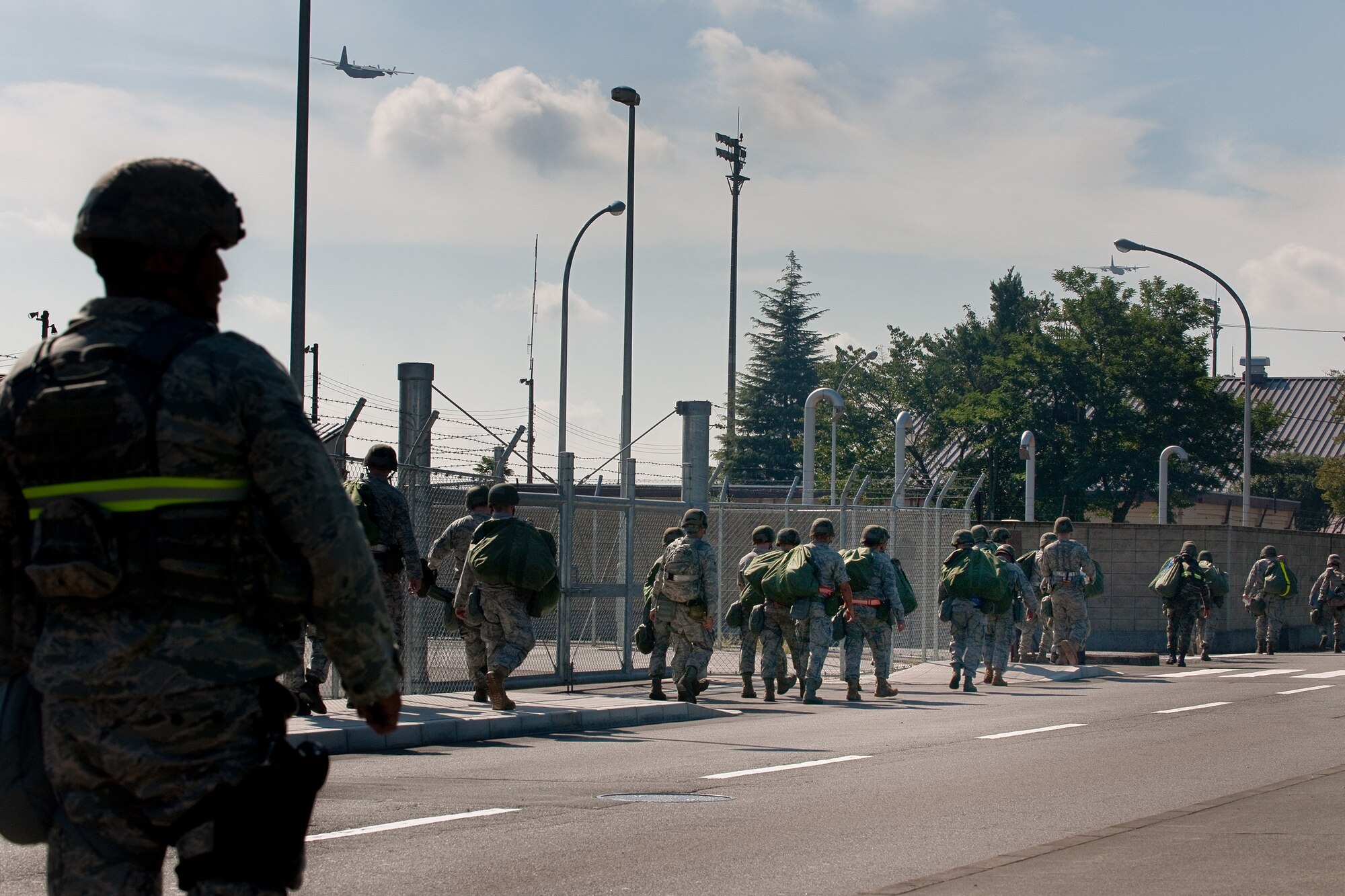 YOKOTA AIR BASE, JAPAN -- Airmen from the 374th Maintenance Squadron evacuate from their facility in response to a simulated unexploded ordnance found at Yokota Air Base, Japan, Sept. 13, 2011 during a wing readiness exercise. (U.S. Air Force photo/Osakabe Yasuo)