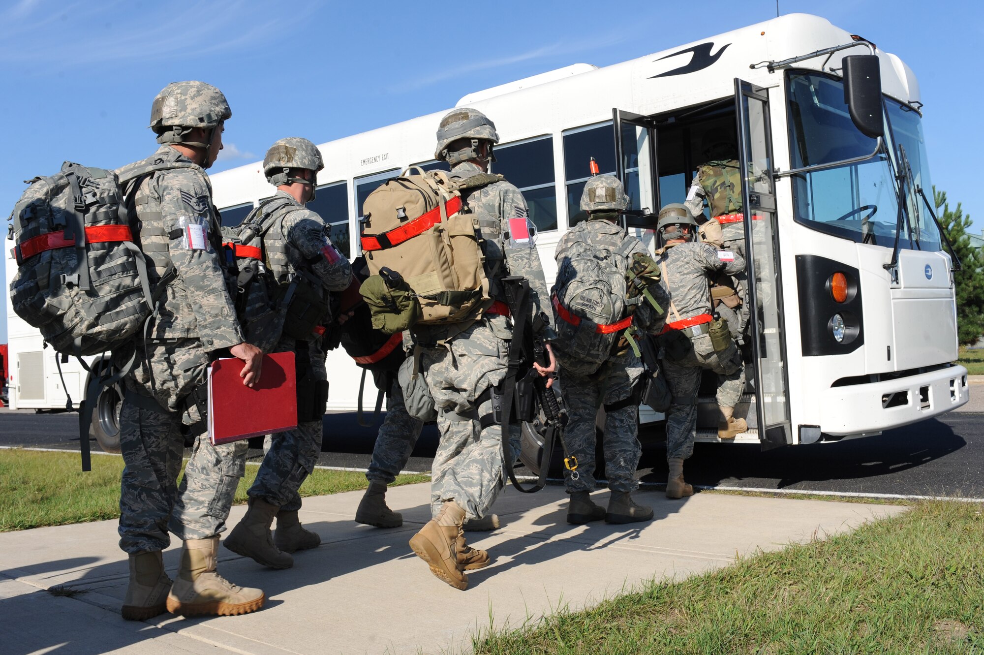 Airmen from Little Rock Air Force Base, Ark., board a bus following a right-start briefing at Volk Field, Wis., Sept. 10, 2011. The briefing started the operational readiness exercise, which is meant to guage the wing's contingency preparedness. 