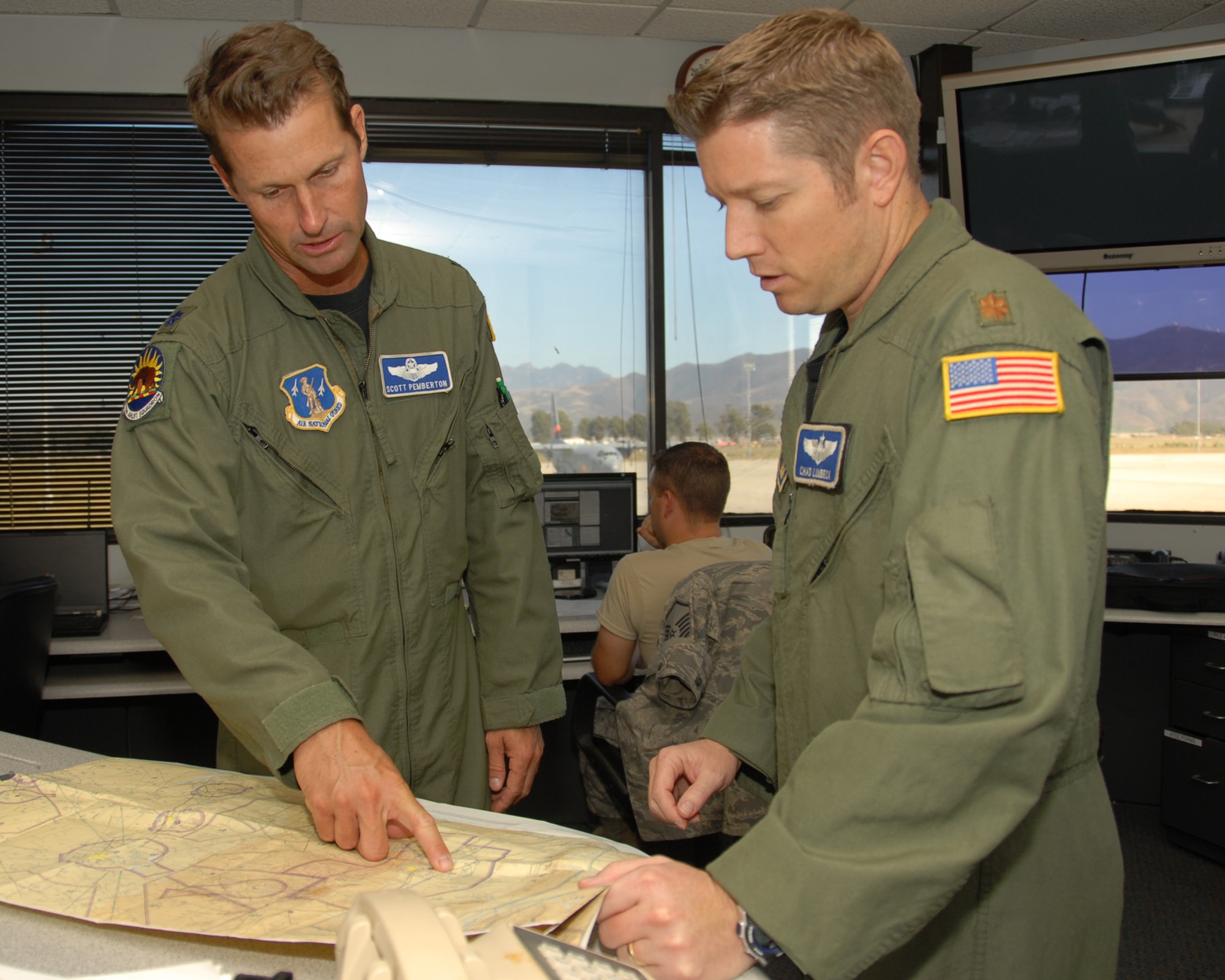 Lt. Col. Scott Pemberton, (left) MAFFS pilot and Maj Chad Lunbeck, (right) MAFFS mission commander locate active fires in the Kern County area on September 12, 2011 at Channel Islands Air National Guard Station, Port Hueneme Calif. (U.S. Air Force photo by SrA Nicholas Carzis.)