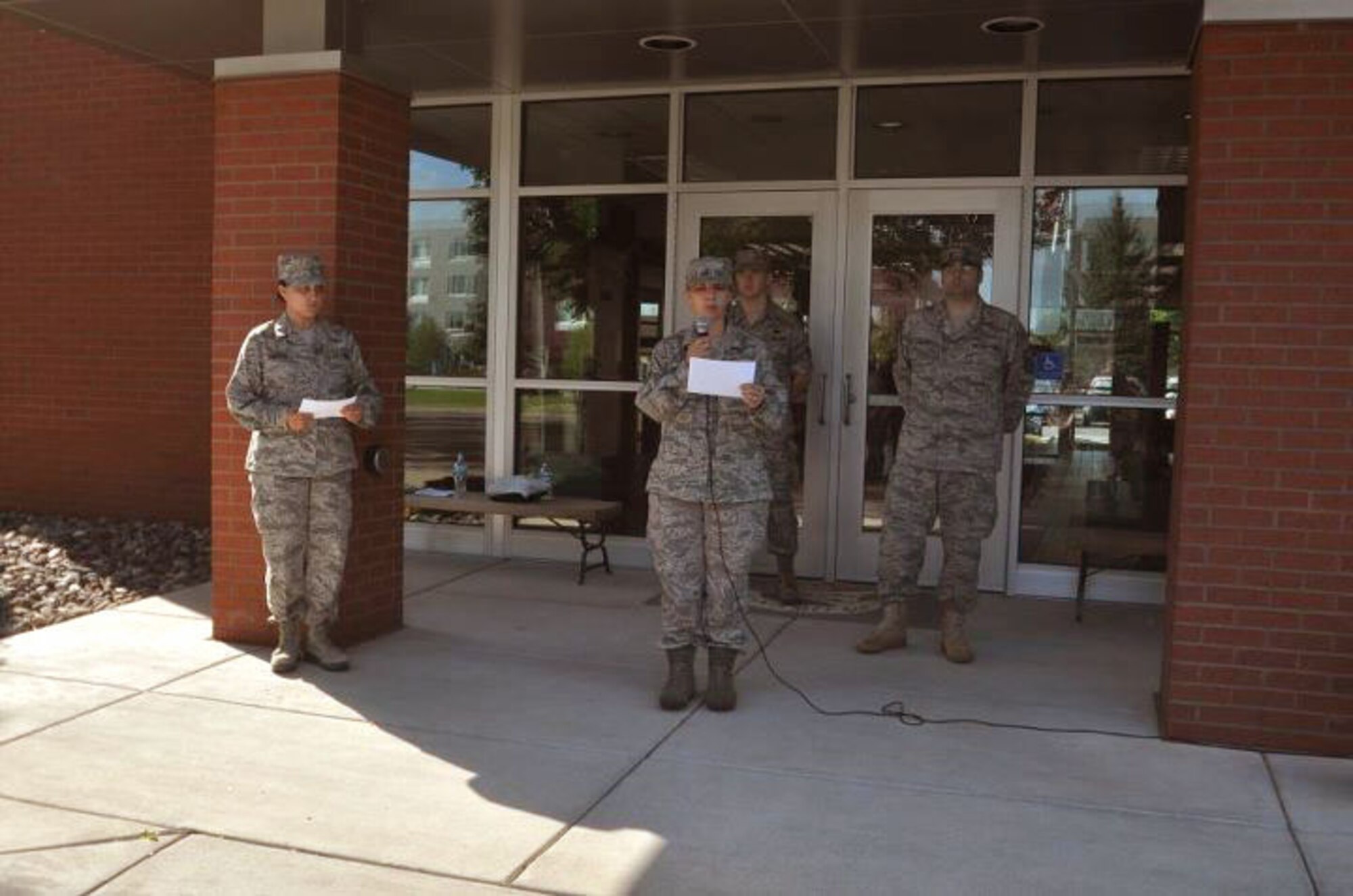 Members of the 934th Airlift Wing, Minneapolis ARS Minnesota, read the timeline of events while takeing a moment to reflect on the events of September 11th 2001. A small remembrance ceremony was held outside the headquarters building Sunday morning. Minneapolis ARS MN. (Air Force Photo/TSgt Bob Sommer)