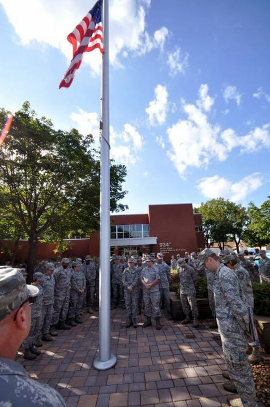 Members of the 934th Airlift Wing, Minneapolis ARS Minnesota, take a moment to reflect on the events of September 11th 2001. A small remembrance ceremony was held outside the headquarters building Sunday morning. Minneapolis ARS MN. (Air Force Photo/TSgt Bob Sommer)