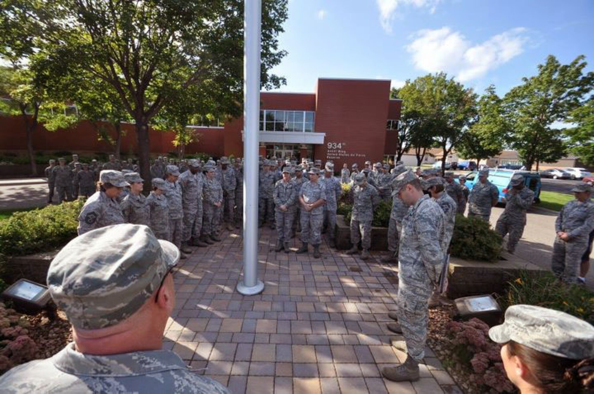 Members of the 934th Airlift Wing, Minneapolis ARS Minnesota, take a moment to reflect on the events of September 11th 2001. A small remembrance ceremony was held outside the headquarters building Sunday morning. Minneapolis ARS MN. (Air Force Photo/TSgt Bob Sommer)