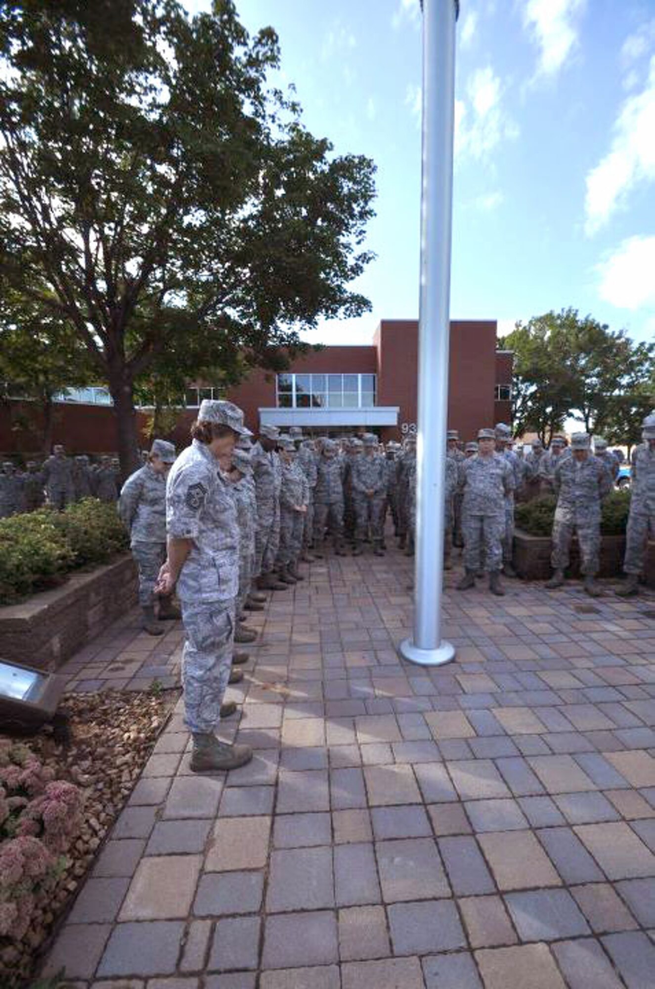 Members of the 934th Airlift Wing, Minneapolis ARS Minnesota, take a moment to reflect on the events of September 11th 2001. A small remembrance ceremony was held outside the headquarters building Sunday morning. Minneapolis ARS MN. (Air Force Photo/TSgt Bob Sommer)