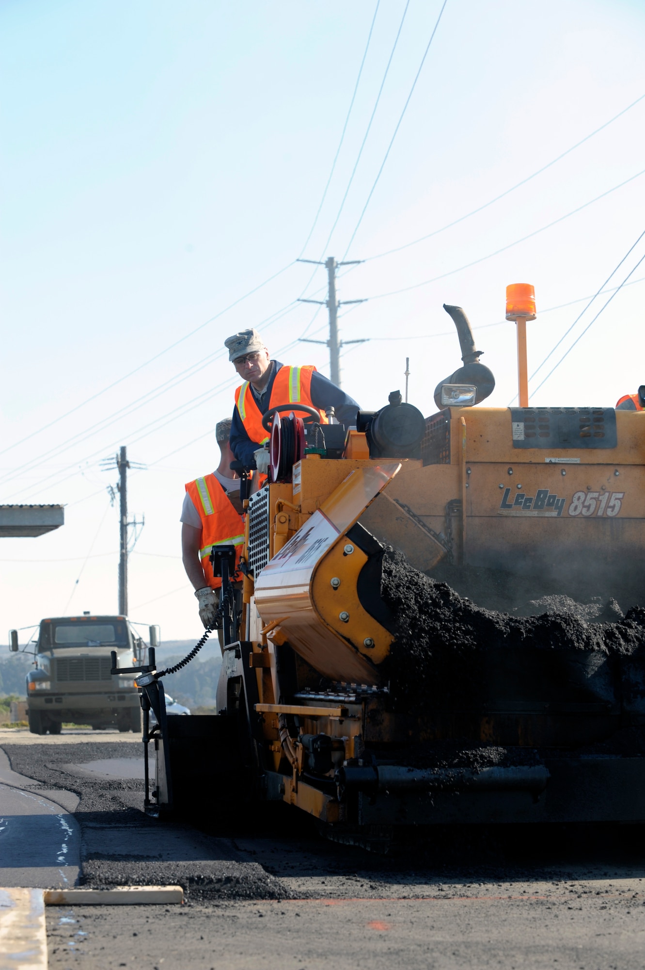 VANDENBERG AIR FORCE BASE, Calif. -- Col. Richard Boltz, 30th Space Wing commander, helps monitor the spreading of asphalt at a parking lot in the civil engineer compound here August 24, 2011. (U.S. Air Force photo/Jerry E. Clemens, Jr.)