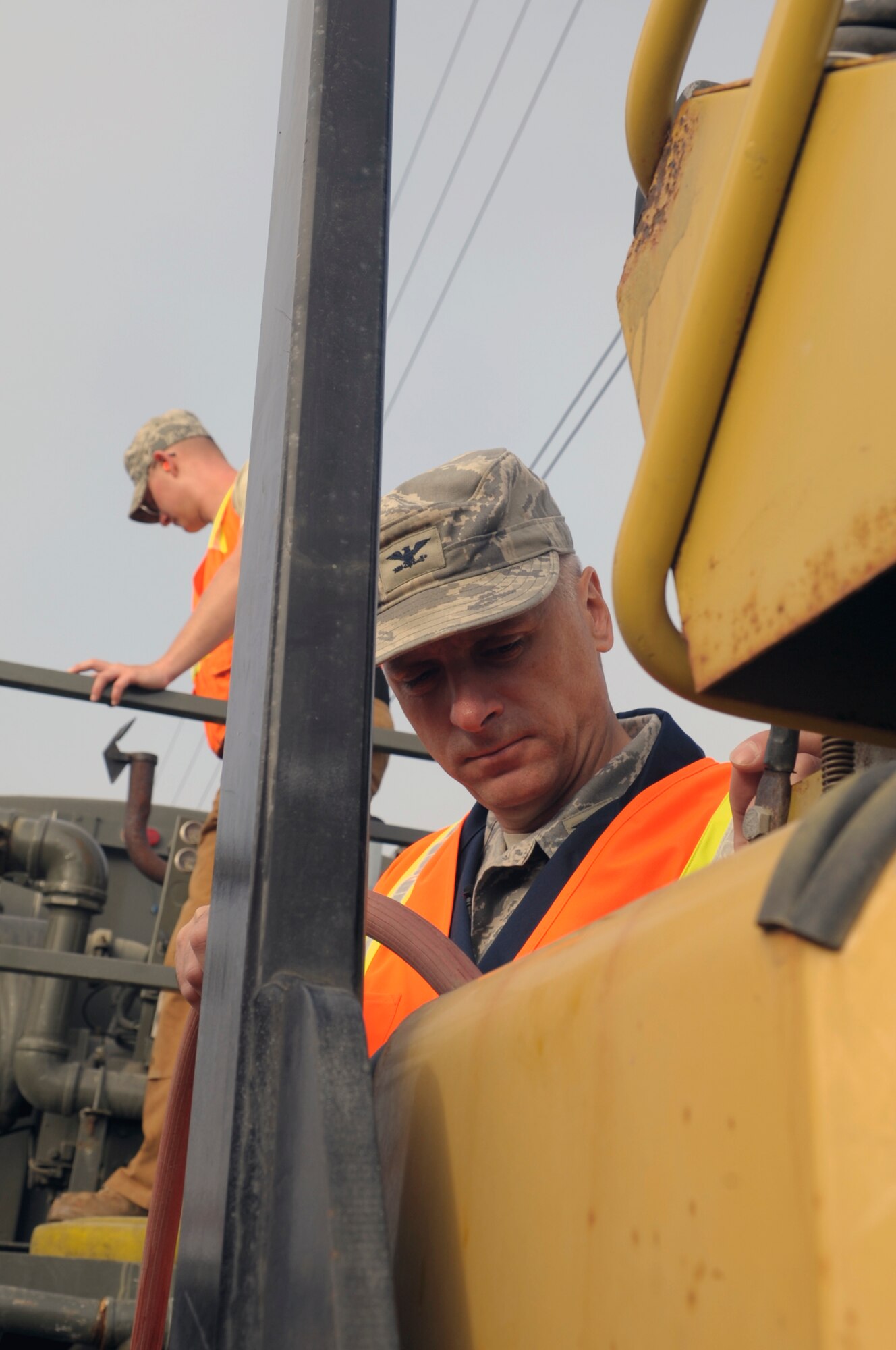 VANDENBERG AIR FORCE BASE, Calif. -- Col. Richard Boltz, 30th Space Wing commander, fills the water tank on an asphalt roller at the 30th Civil Engineer Squadron compound parking lot here Wednesday, Aug. 24, 2011. (U.S. Air Force photo/Jerry E. Clemens, Jr.)