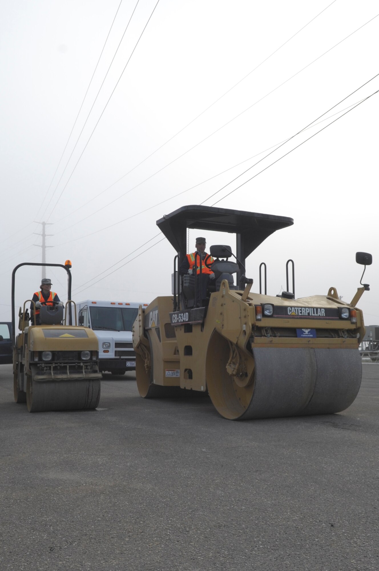 VANDENBERG AIR FORCE BASE, Calif. - Col. Richard Boltz, 30th Space Wing commander, and Chief Master Sgt. Michelle Sobel, 30th SW acting command chief, pose on asphalt rollers at the 30th Civil Engineer Squadron compound parking lot here Wednesday, Aug. 24, 2011. (U.S. Air Force photo/Jerry E. Clemens, Jr.)