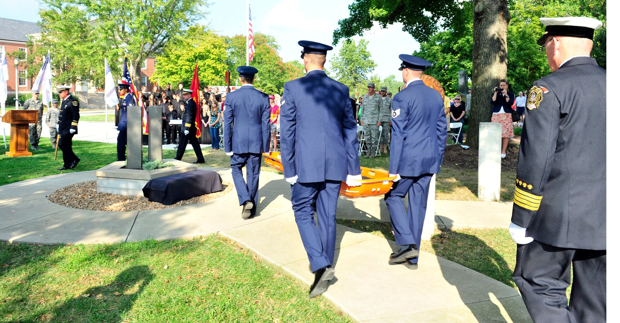 Several 375th Civil Engineer Squadron fire protection Airmen carry the World Trade Center beam during the 9/11 observance ceremony here.  The group carried the piece to team Scott firefighters who then laid to rest atop the Scott AFB 9/11 memorial. The memorial was created for Team Scott and visitors to remember the fellow Americans who died on 9/11. (U.S. Air Force photo, Staff Sgt. Stephenie Wade) 