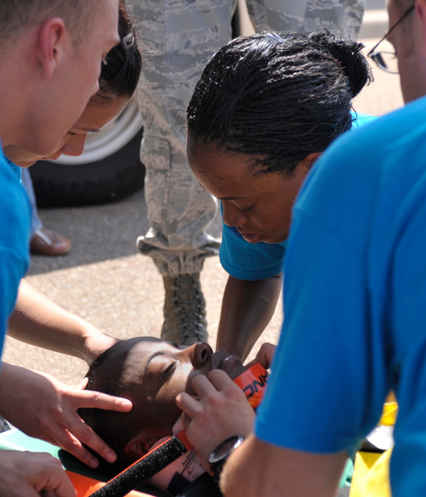 Emergency medical team members from Kirkland Air Force Base, N.M., tend to a patient in a timed scenario during the Emergency Medical Technician Rodeo at Cannon Air Force Base, N.M., Sept. 10, 2011. Nine teams of EMT?s from bases across the United States and Germany competed in the EMT Rodeo which consisted of several simulated scenarios designed to test each team?s skills. (U.S. Air Force photo by Airman 1st Class Ericka Engblom)
