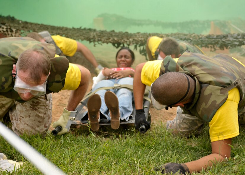 The emergency medical team from Fort Sam/Huston, Texas., crawls through an obstacle course as part of the Emergency Medical Technician Rodeo at Cannon Air Force Base, N.M., Sept. 10, 2011. The EMT Rodeo is a competition in which EMT teams from across the United States and Germany test their skills in various events that simulate real life scenarios. (U.S. Air Force photo by Airman 1st Class Ericka Engblom)