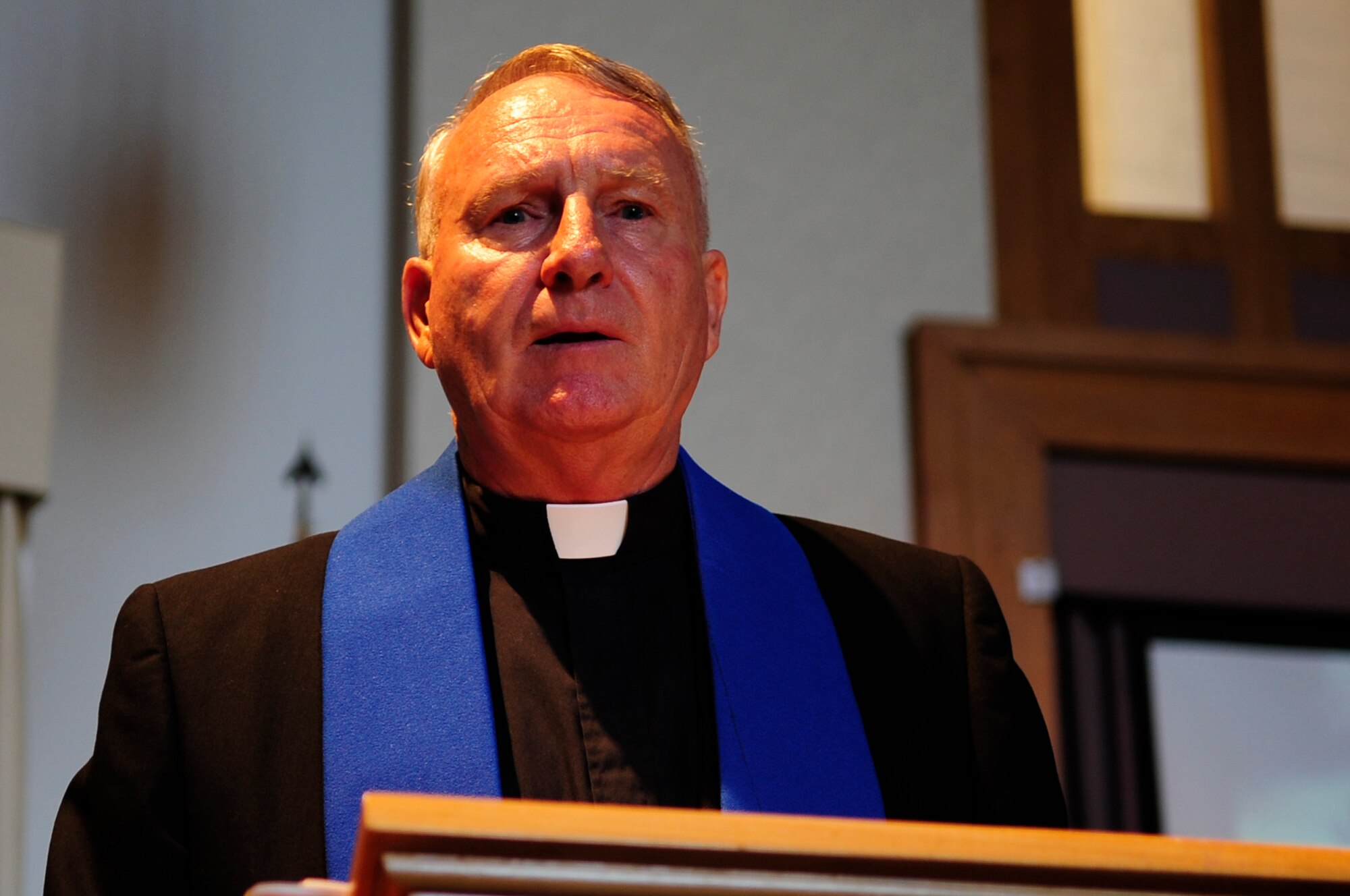 VANDENBERG AIR FORCE BASE, Calif. – Chaplain (Col.) Thomas Kelly, 30th Space Wing catholic priest, prays during a 9/11 Memorial Ceremony at Chapel 1 here Monday, Sept. 12, 2011.  The ceremony was in remembrance of the victims the 9/11 terrorist attacks. (U.S. Air Force photo/Senior Airman Lael Huss)