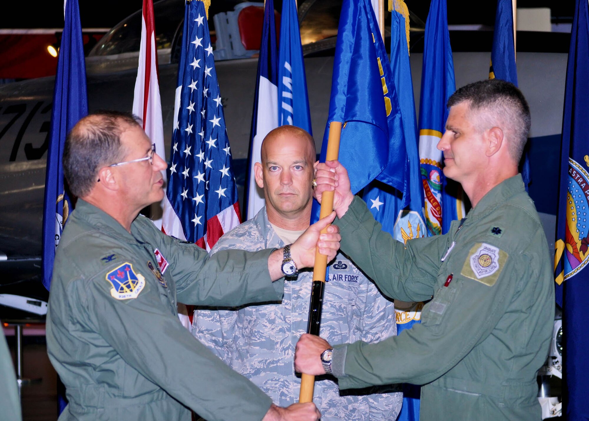 EGLIN AIR FORCE BASE, Fla. -- (Right) Lt. Col. Brian Silkey, 84th Test and Evaluation Squadron commander, receives the guideon from Col. Herman Brunke, Jr., 926th Group commander (left), during an assumption of command ceremony at the Air Force Armament Museum on Sept. 6. Colonel Silkey is responsible for leading the squadron in its mission of providing long-term continuity and credibility to the 53rd Wing, Eglin AFB by integrating highly-experienced aircrew, maintenance, intelligence and communications specialists. (Photo courtesy of 84th TES)
