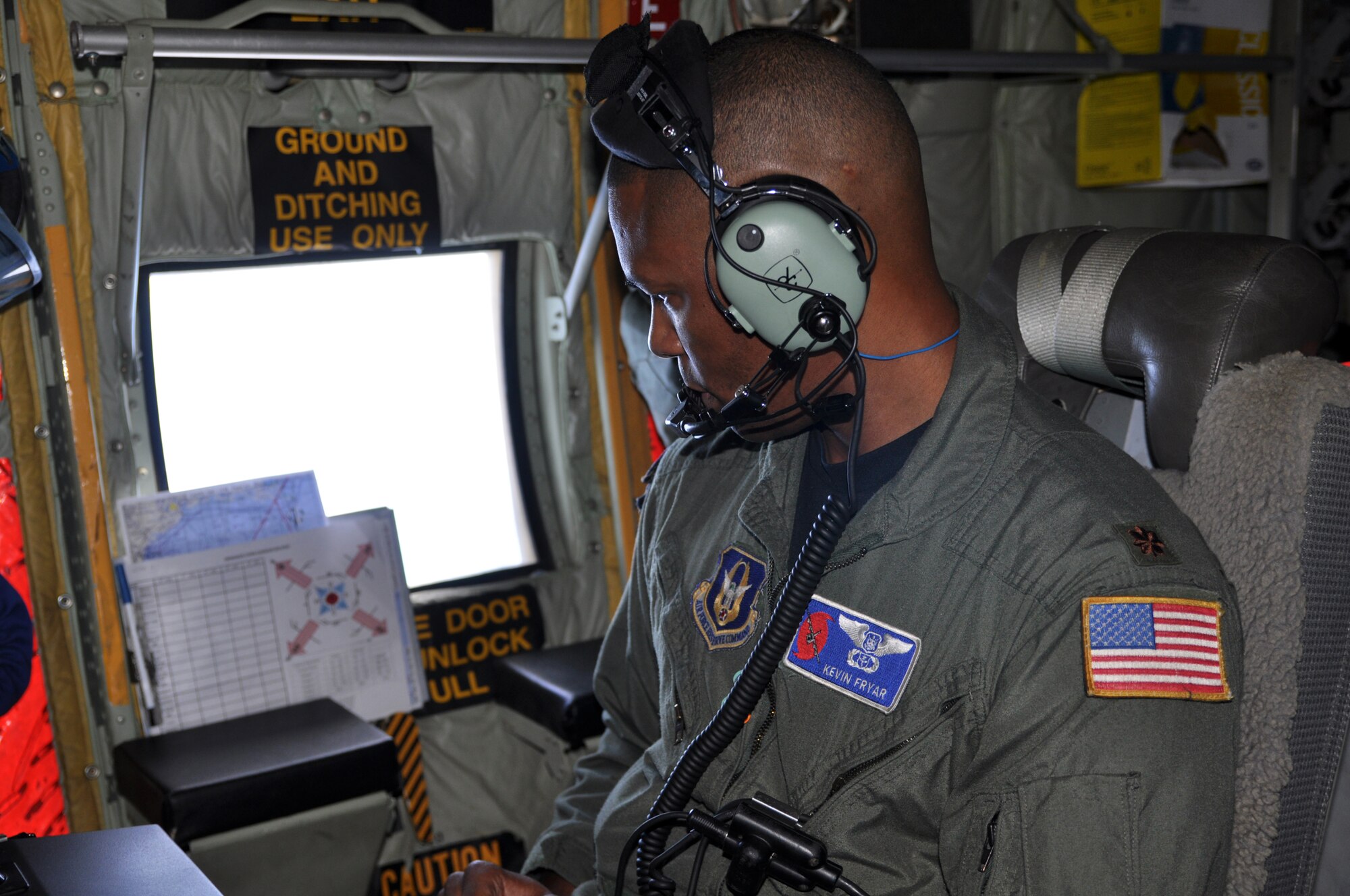 Maj. Kevin Fryar, an aerial reconnaissance weather officer with the 53rd Weather Reconnaissance Squadron, looks out the window to monitor the weather conditions from Tropical Storm Nate Sept. 7. The flight meteorologist acts as the flight director while observing and recording meteorological data. (U.S. Air Force photo by Staff Sgt. Valerie Smock)