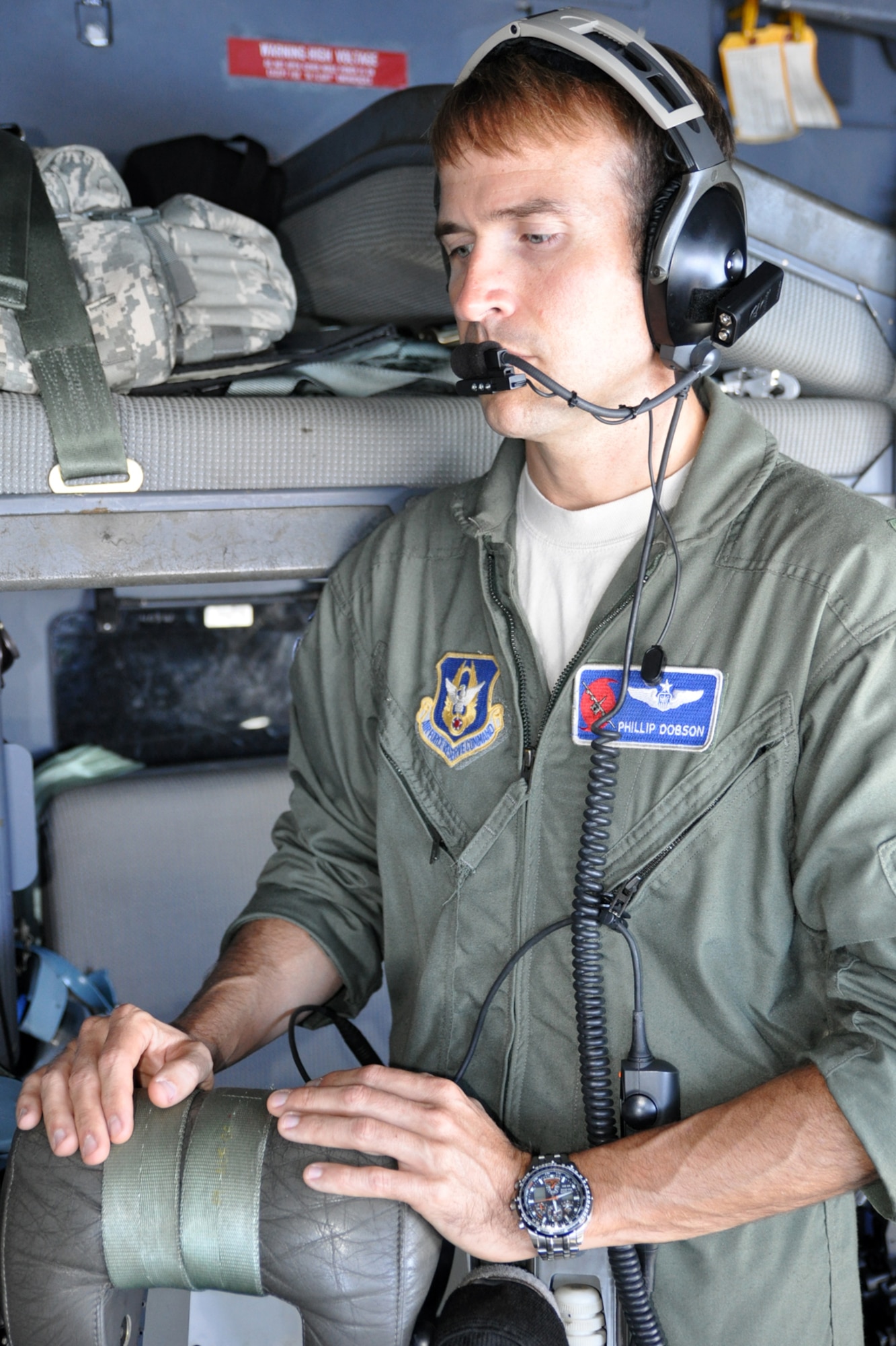 Maj. Phillip Dobson, a navigator with the 53rd Weather Reconnaissance Squadron, watches over another navigator as they prepare to fly into Tropical Storm Nate Sept. 7. The storm generated in the Gulf of Mexico and moved west into Mexico. (U.S. Air Force photo by Staff Sgt. Valerie Smock)