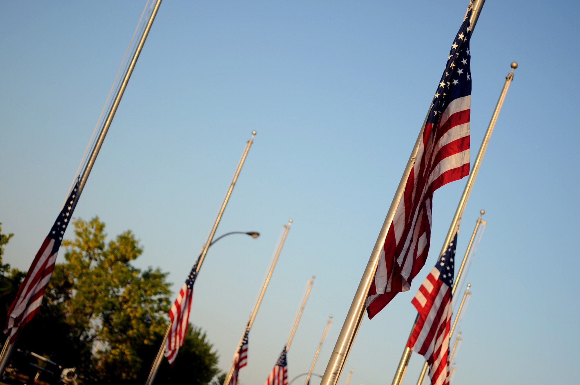 U.S. Flags are raised to half mast for 9/11 remembrance on Grand Forks Air Force Base Sept 11. The ceremony marked the 10 year anniversary of the terrorist attacks in New York, Pennsylvania and Washington D.C. (U.S Air Force photo by Senior Airman Amanda N. Stencil) 