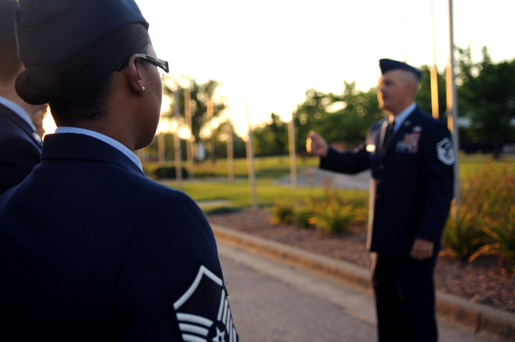 Master Sgt. Tameka Morales-Long, 319th Force Support Squadron, listens to Master Sgt. John Smith, 319th Communications Squadron, before the 9/11 Remembrance Ceremony on Grand Forks Air Force Base Sept 11. The ceremony marked the 10 year anniversary of the terrorist attacks in New York, Pennsylvania and Washington D.C. (U.S Air Force photo by Senior Airman Amanda N. Stencil)