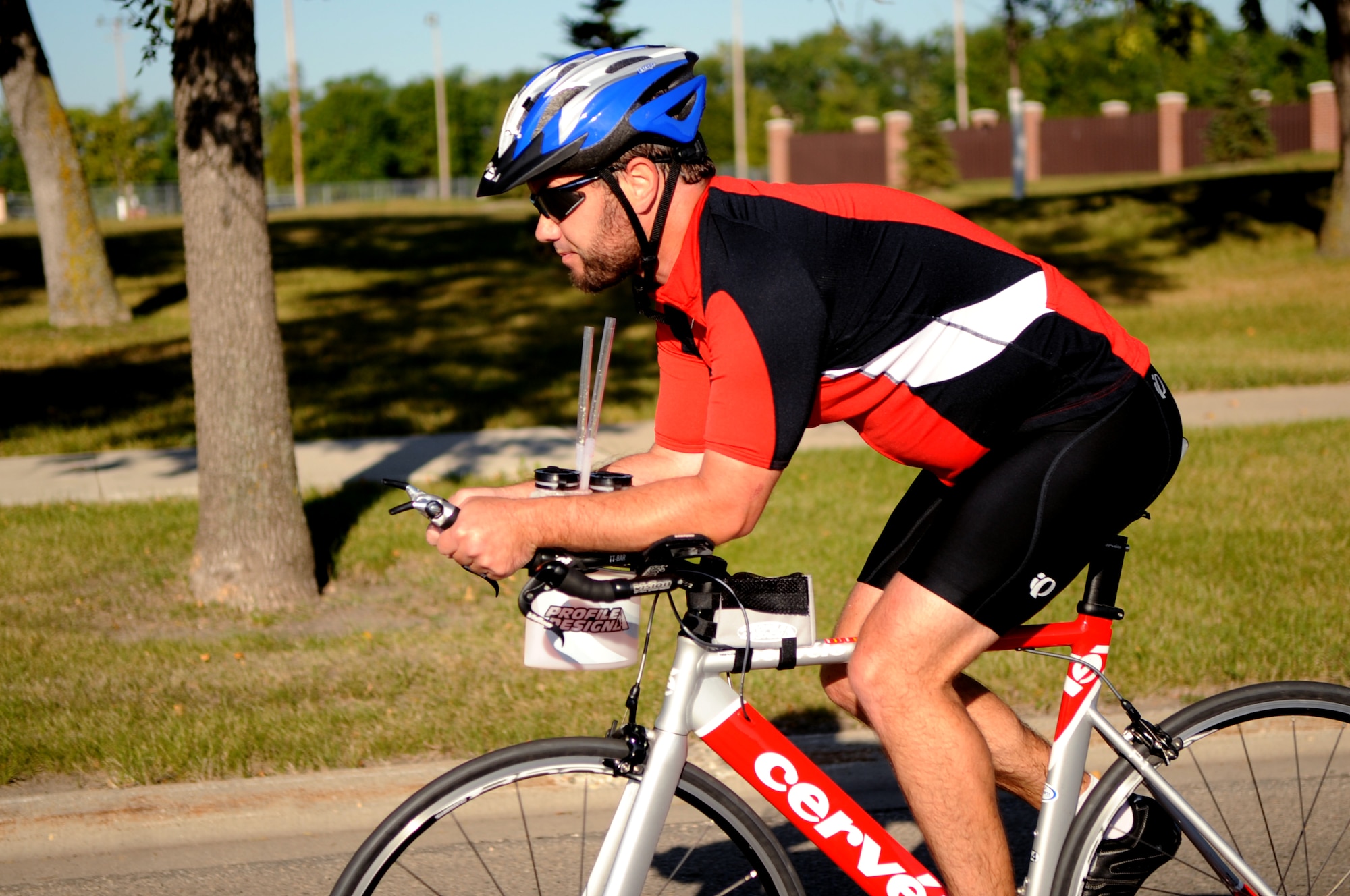 Travis Pugh, husband of Tech. Sgt. Henrietta Pugh, 9th Reconnaissance Squadron, competes in the bike portion of the triathlon on Grand Forks Air Force Base Sept 10. GFAFB sponsored a sprint triathlon which consisted of a 750m swim, 12km bike ride and a 5km run. (U.S Air Force photo by Senior Airman Amanda N. Stencil)