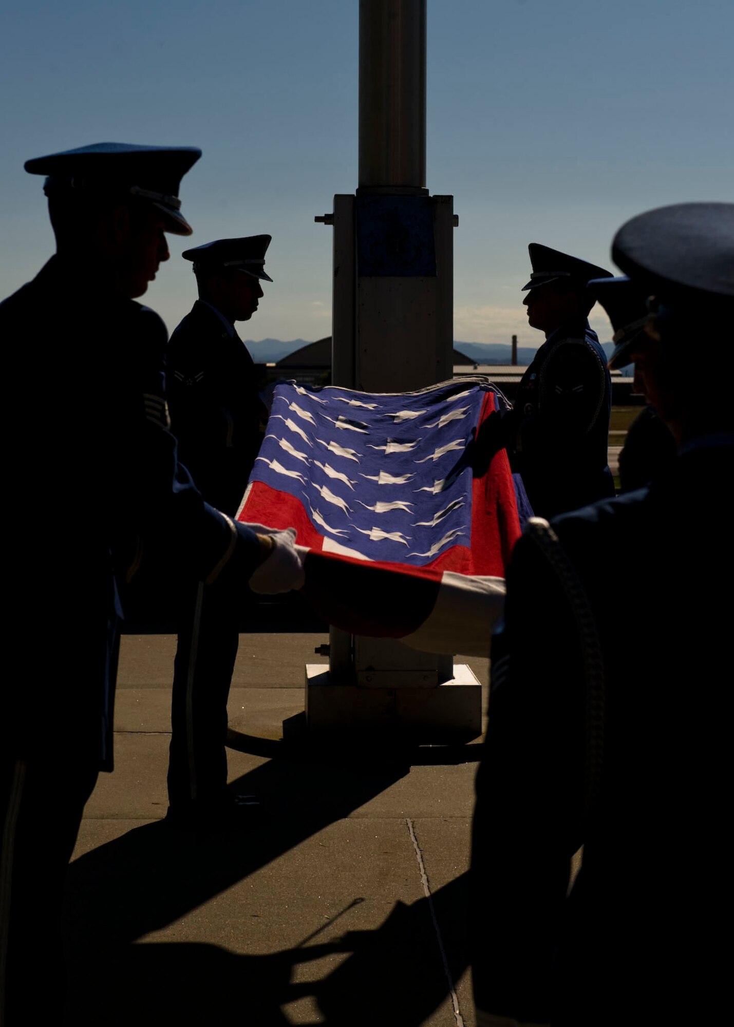 Airmen from the Ellsworth Air Force Base Honor Guard perform the flag folding at the POW/MIA and 9/11 Remembrance Retreat Ceremony in front of the 28th Bomb Wing Headquarters on Ellsworth Air Force Base, S.D., Sept. 9, 2011. The ceremony was held to commemorate those lives lost in war-time and the terrorist attacks on September 11, 2001. (U.S. Air Force photo by Airman 1st Class Kate Thornton/Released)