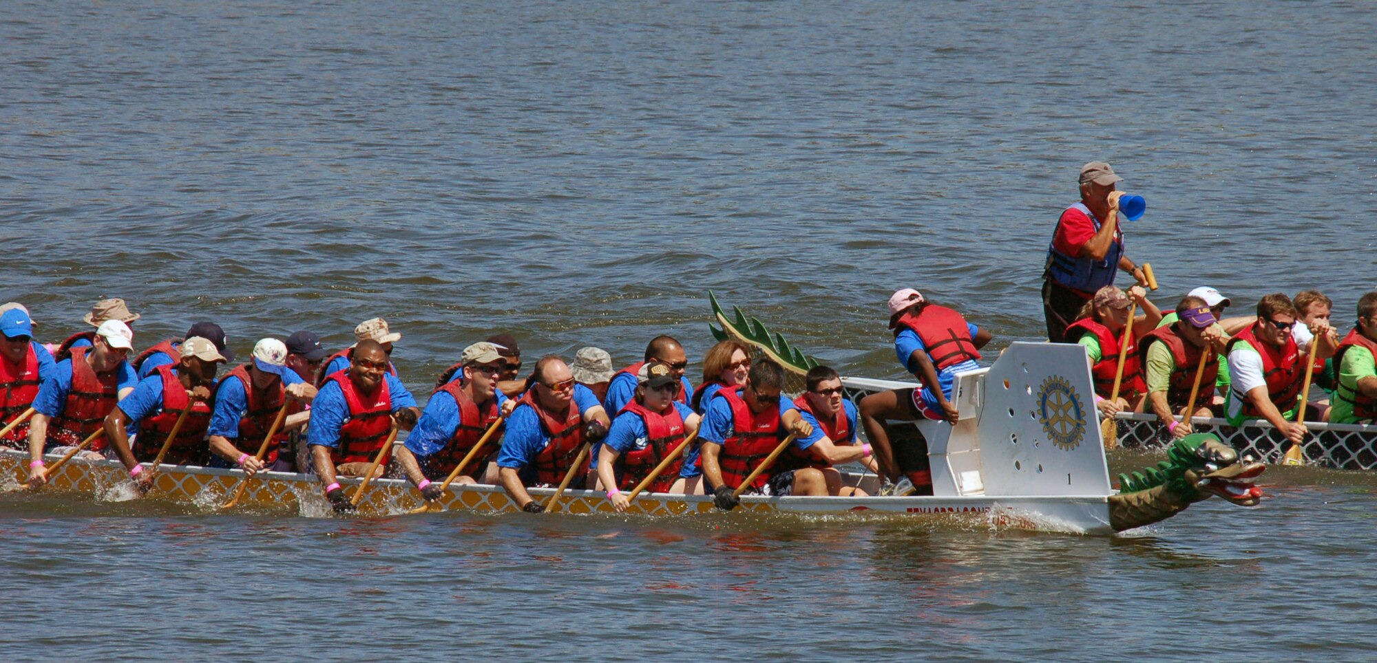 SHREVEPORT, La. – Members of the “Mighty Eighth” dragon boat team (blue shirts) tries to catch up to another team in the dragon boat races during the third annual Red River Dragon Boat Festival Sept. 10, 2011. This year's race featured 27 teams, all vigorously paddling 41-foot-long boats to the finish line. Each team is comprised of a minimum of 20 paddlers, a captain and a drummer who beats the cadence as they paddle. (U.S. Air Force photo by Staff Sgt. Brian Stives)
