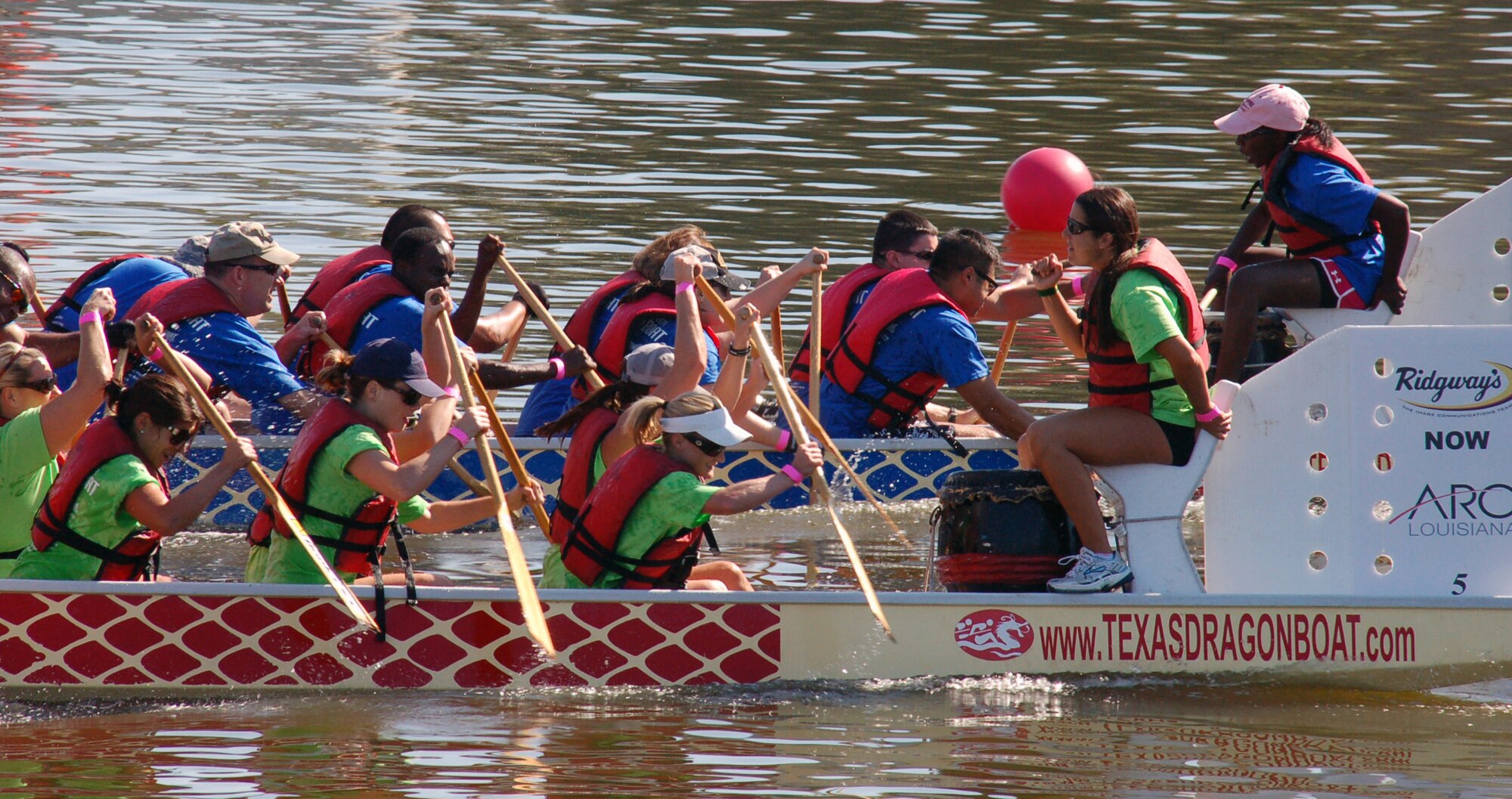 SHREVEPORT, La. – Members of the “Mighty Eighth” dragon boat team (blue shirts) tries to hold off a late rally by another team in the dragon boat races during the third annual Red River Dragon Boat Festival Sept. 10, 2011. This year's race featured 27 teams, all vigorously paddling 41-foot-long boats to the finish line. Each team is comprised of a minimum of 20 paddlers, a captain and a drummer who beats the cadence as they paddle. (U.S. Air Force photo by Staff Sgt. Brian Stives)
