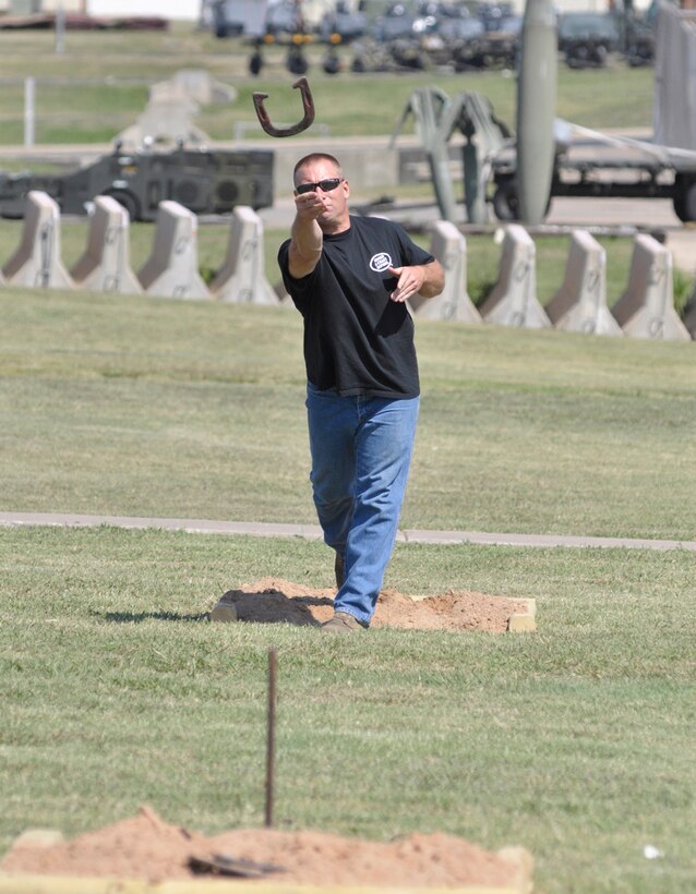 TSgt James Pranger, 138th MXS, tosses a horseshoe while competing in the annual hoseshoe tournament held during a Family Day celebration at the 138th Fighter Wing, Oklahoma Air National Guard base in Tulsa, OK.  (U.S. Air Force Photo by:  Master Sergeant Preston Chasteen)