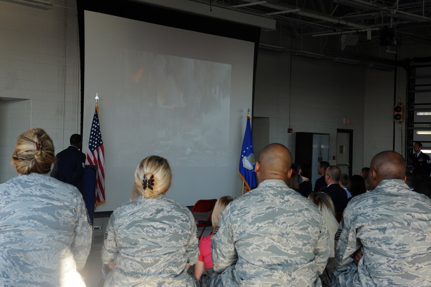 Team Seymour members watch a slide show on the events that occurred on Sept. 11, 2001 during a remembrance ceremony on Seymour Johnson Air Force Base, N.C., Sept. 11, 2011. All the deaths in the attacks were civilians, except for 55 military personnel killed at the Pentagon.  (U.S. Air Force photo by Senior Airman Whitney Lambert)