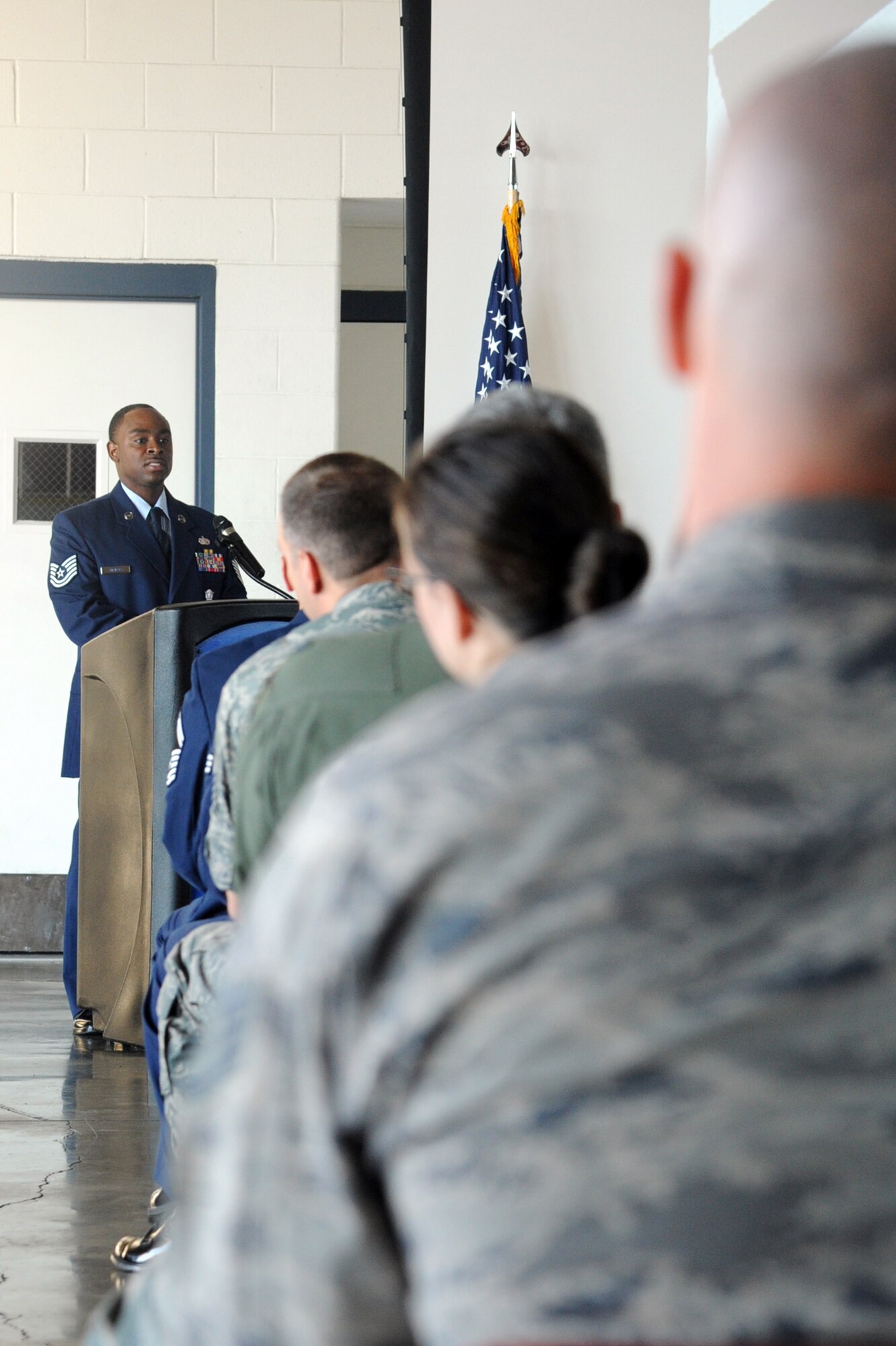 Tech. Sgt Darion Shrieves master of ceremonies during a 9/11 remembrance ceremony on Seymour Johnson Air Force Base, N.C., Sept. 11, 2011. Shrieves read to the crowd the timeline events that occured on Sept. 11, 2001. Shrieves is a 4th Security Forces Squadron standardization evaluator and a native of Baltimore, Md. (U.S. Air Force photo by Senior Airman Whitney Lambert) 