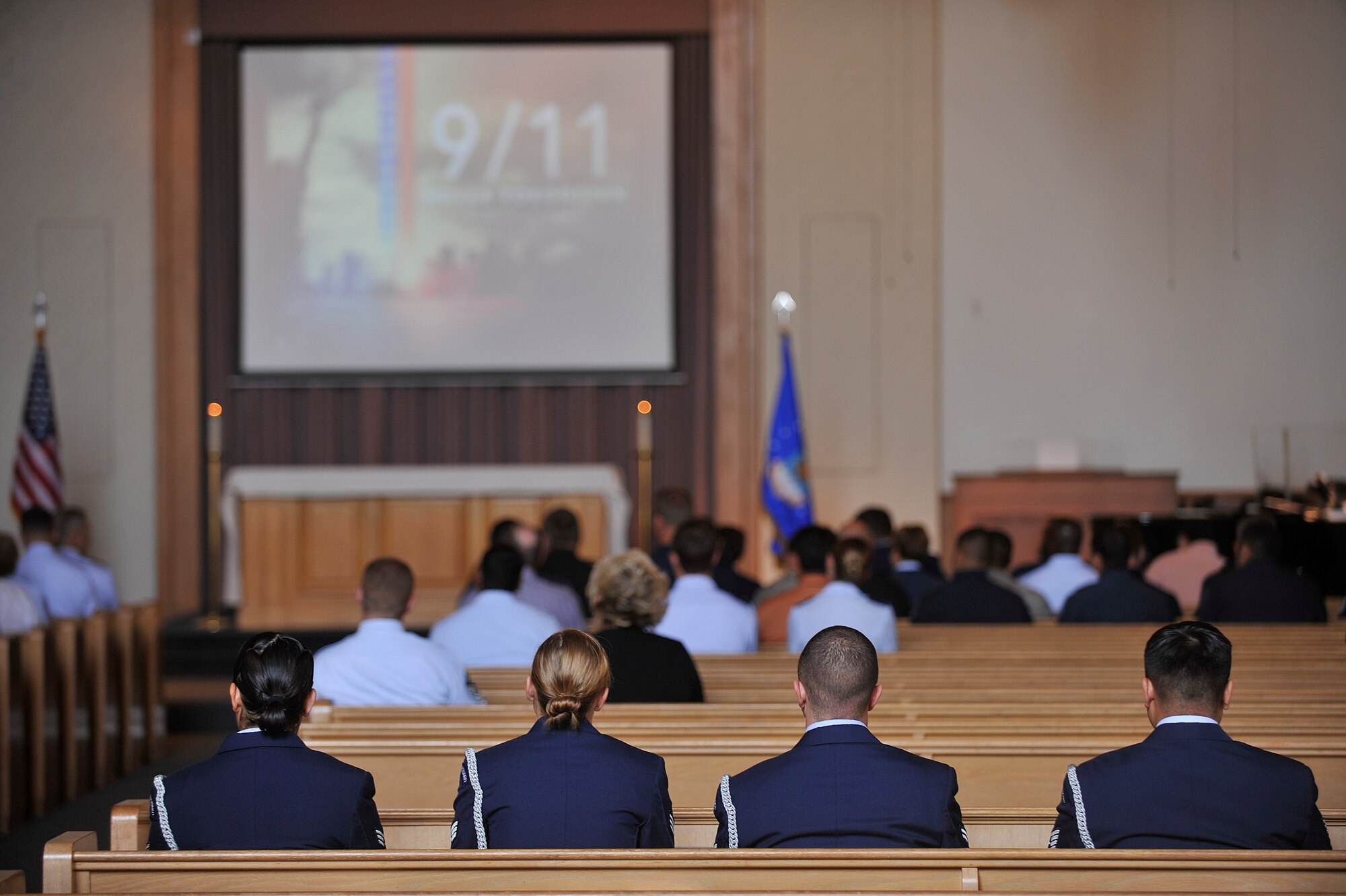 VANDENBERG AIR FORCE BASE, Calif. -- Team V members listen to Col. Richard Boltz, 30th Space Wing commander, speak during a 9/11 memorial ceremony at the base chapel here Monday, Sept. 11, 2011. The ceremony paid tribute to fallen heroes of the 9/11 attacks. (U.S. Air Force photo/Staff Sgt. Andrew Satran) 

   
 