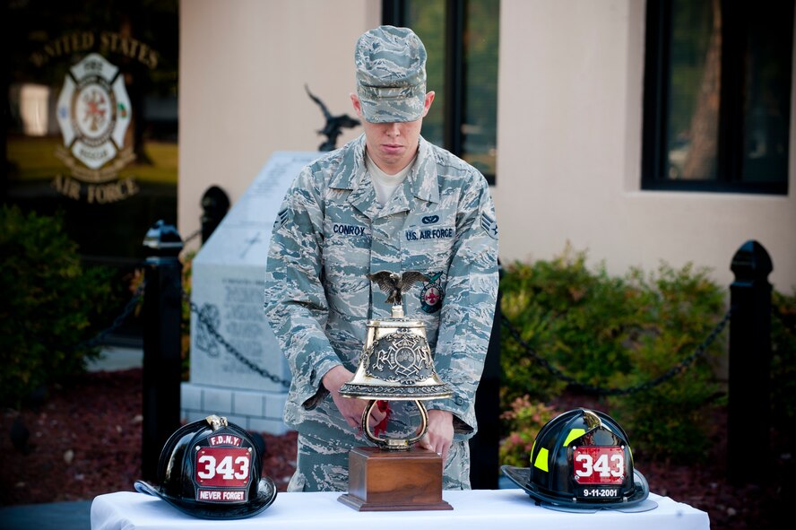 U.S. Air Force Senior Airman Christopher Conroy, a firefighter with the 23rd Civil Engineer Squadron, performs the last bell ritual during the 9-11 memorial ceremony on Moody Air Force Base, Ga. on Sept. 11, 2011. The ritual is done for every firefighter that has given their life in the call of duty. (U.S. Air Force photo by Staff Sgt. Joshua J. Garcia/Released)