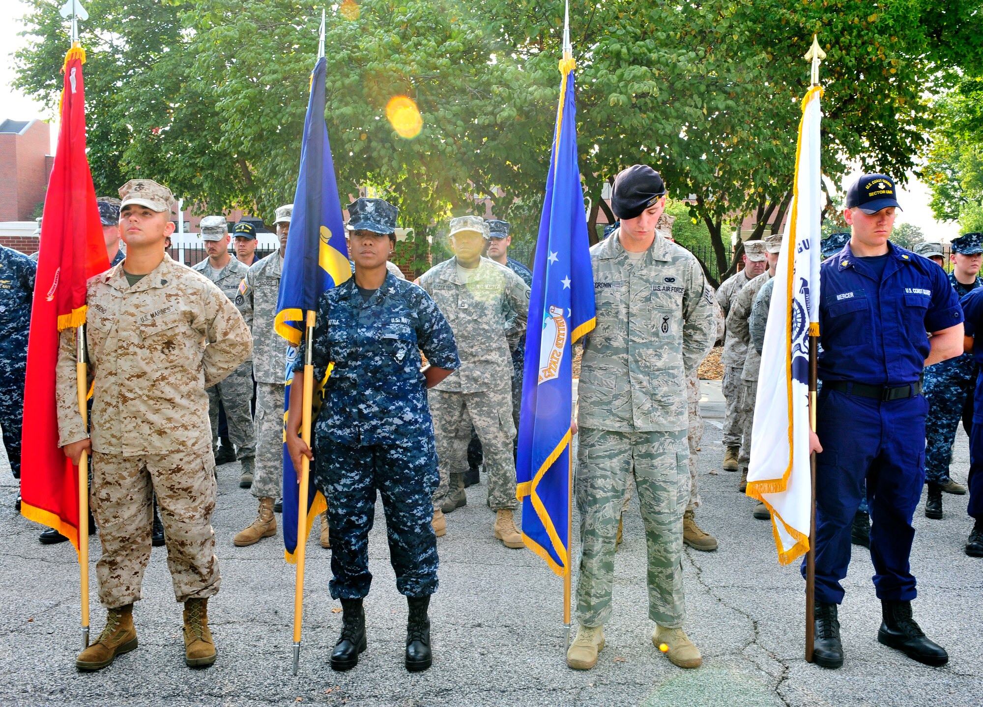 Representatives from all branches bow their head during a moment of silence at the 9/11 observance ceremony here. The group carried the piece to awaiting Team Scott firefighters who laid it to rest atop the Scott AFB 9/11 memorial. The memorial was created for Team Scott and visitors to remember the fellow Americans who died on 9/11. (U.S. Air Force photo, Staff Sgt. Stephenie Wade) 