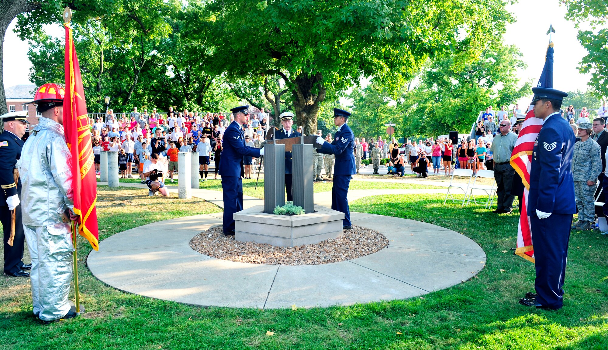 Airman 1st Class Stephen Mcnulty and Staff Sgt. Solomon Rigsby, 375th Civil Engineer Squadron fire protection, complete the Scott Air Force base 9/11 memorial. The memorial was created for Team Scott and visitors to remember fellow Americans who died on 9/11. The Scott monument is made of four pieces: a pentagon shaped-planter constructed of Indiana limestone--the same material used in the façade of the Pentagon. Within the planter, new foliage representing life is planted in soil from Pennsylvania; Twin Tower replicas emerge from the center, made of brushed steel in the same style as the fallen towers. And a steel beam from the Twin Towers. The monument now offers a place of reflection for families, military members and civilian guests. (U.S. Air Force photo, Staff Sgt. Stephenie Wade)