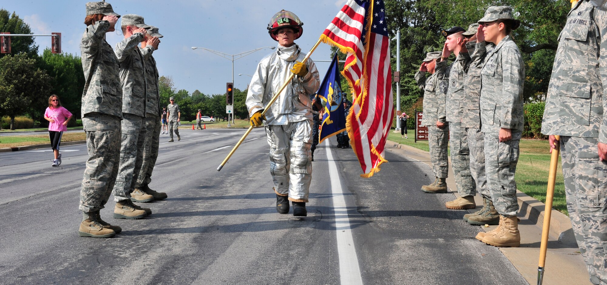 Staff Sgt. Randall Forsythe, 375th Civil Engineer Squadron fire protection, leads the formation during the 2 mile 9/11 observance remembrance run here.  During the run, service branch representatives took turns bearing the beam until it was laid to rest atop the Scott AFB 9/11 monument. (U.S. Air Force photo, Staff Sgt. Stephenie Wade) 
 

