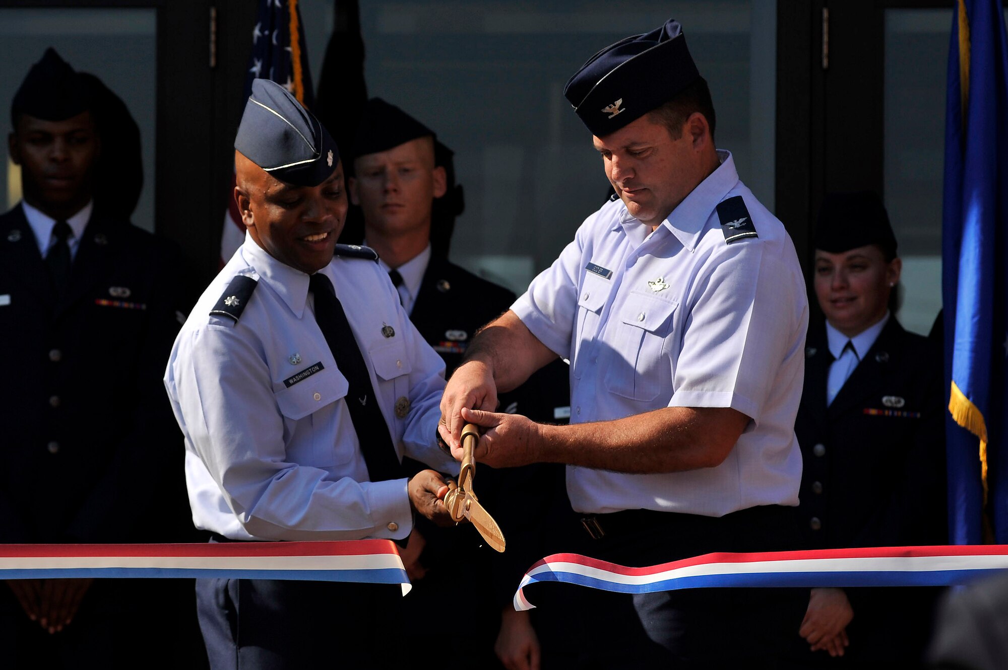 U.S. Air Force Lt. Col. Dalian Washington, 20th Force Support Squadron commander, (left) and Col. Don Godier, 20th Fighter Wing vice commander, cut the ribbon to officially open the new fitness center addition, Sept. 12, 2011, Shaw Air Force Base, S.C. The approximately 25,000 sq. ft. addition adds a new cardio room, weight room and a men's locker room and a women's locker room. (U.S. Air Force photo by Senior Airman Kenny Holston)(Released)

