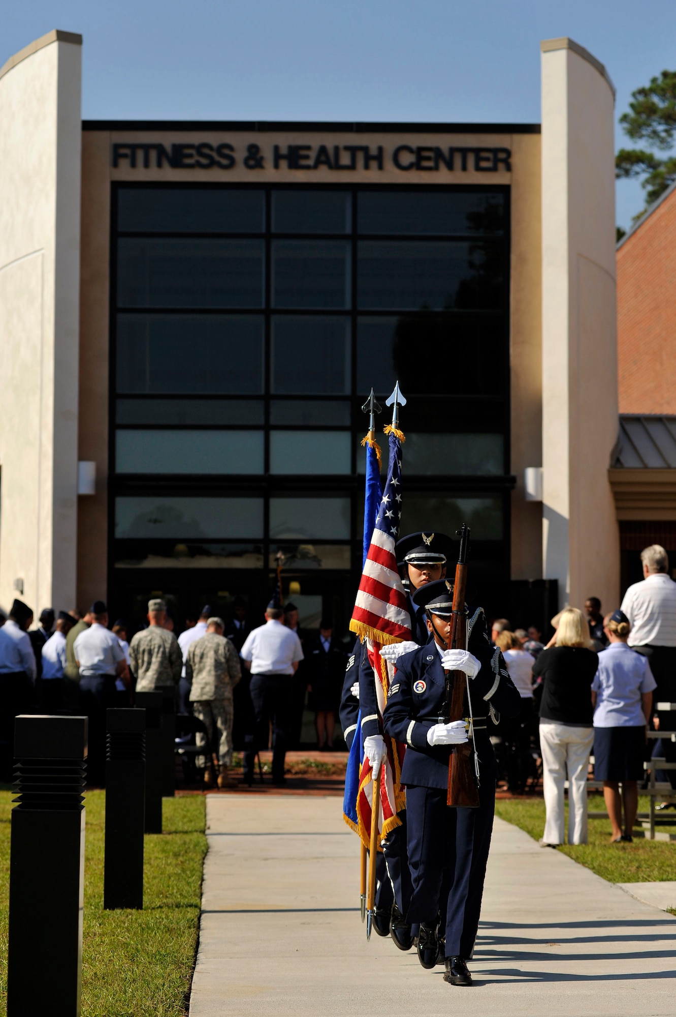 Shaw Air Force Base Honor Guard marches into position after posting the Colors during the grand opening of the new fitness center addition, Sept. 12, 2011. The approximately 25,000 sq. ft. addition adds a new cardio room, weight room and a men's and a women's locker room. (U.S. Air Force photo by Senior Airman Kenny Holston)(Released)

