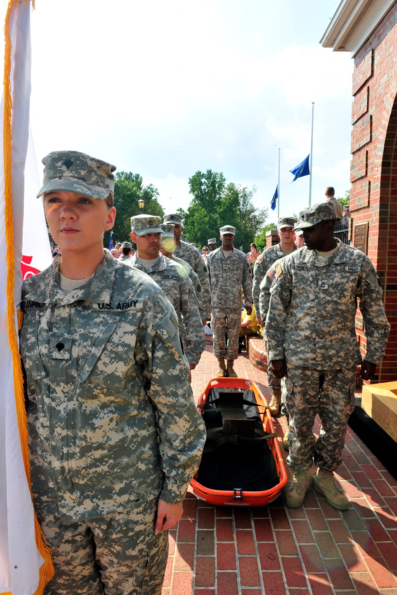 Surface Deployment Distribution Command Soldiers get ready to carry the World Trade Center beam on a litter during the 2 mile 9/11 observance remembrance run here.  On the 10th anniversary of 9/11, representatives from all five service branches took turns carrying the World Trade center steel beam until it was laid to rest atop the Scott AFB 9/11 monument. (U.S. Air Force photo, Staff Sgt. Stephenie Wade) 