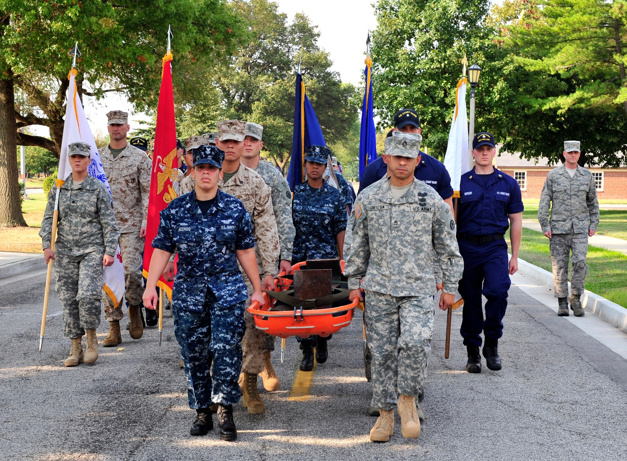 Representatives from all branches bear the World Trade Center steel beam during the 9/11 observance ceremony here. The group carried the piece to awaiting Team Scott firefighters who laid it to rest atop the Scott AFB 9/11 memorial. The memorial was created for Team Scott and visitors to remember the fellow Americans who died on 9/11. (U.S. Air Force photo, Staff Sgt. Stephenie Wade) 