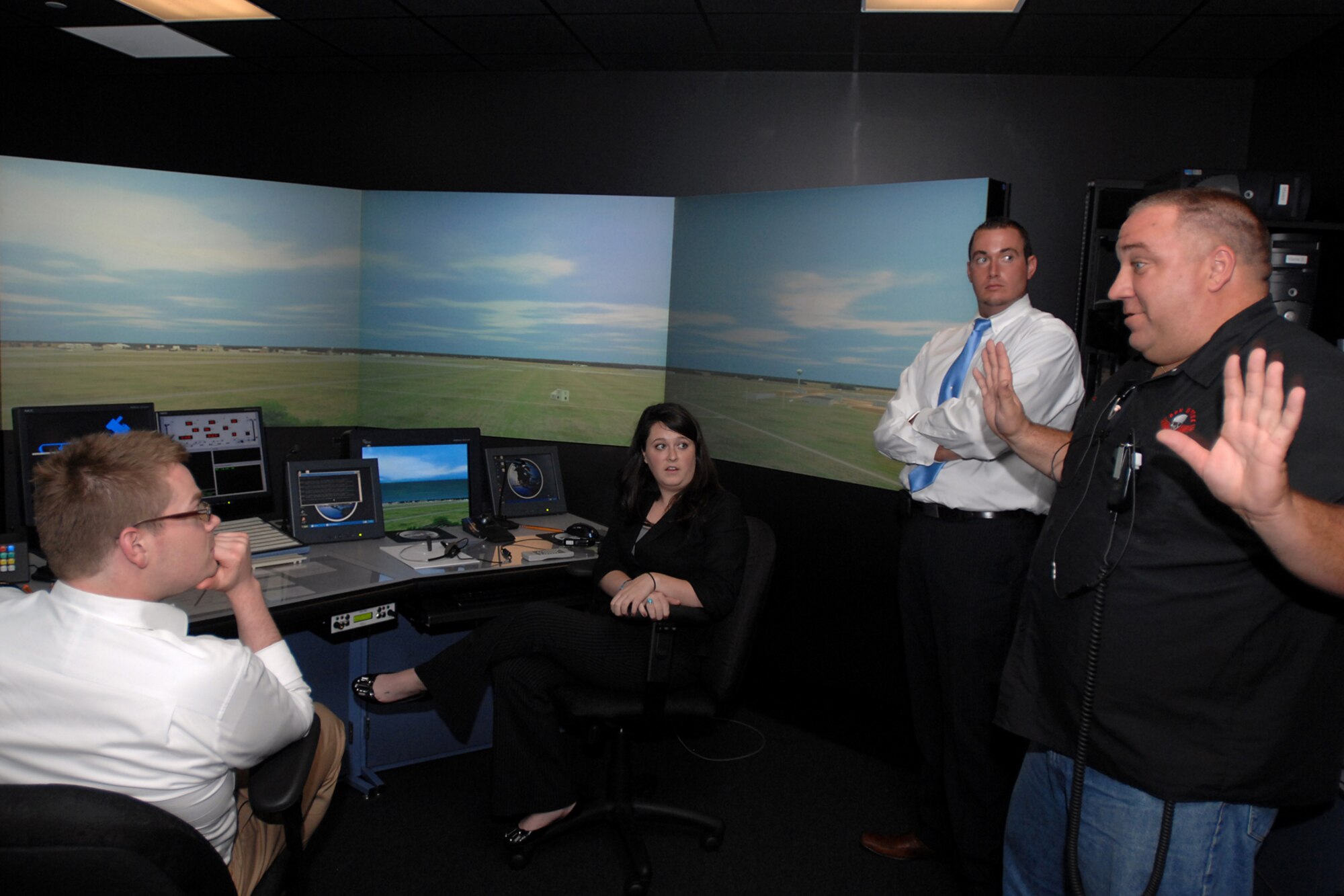 GRISSOM AIR RESERVE BASE, Ind. -- Congressional staff members get a chance to experience an air traffic control simulator on Aug. 9. Their visit to the base gave them the opportunity to see Grissom first-hand, and understand how different areas operate. Pictured from left is Nathan Fenstermacher, legislative director for Congressman Joe Donnelly; Katie Wachtler, executive assistant for Congressman Dan Burton; Jack Middleton, director of community relations for Congressman Dan Burton; and John Rhoutsong, 434th Operations Support Squadron air traffic controller. (U.S. Air Force photo/Senior Airman Jami K. Lancette)