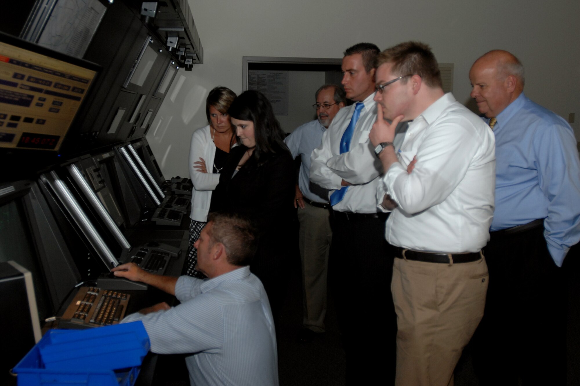 GRISSOM AIR RESERVE BASE, Ind. -- Congressional staff members visit the Grissom radar approach control flight instrument rule room during their visit here Aug. 9. Their tour of Grissom was aimed at giving them better insight into the operations here. Pictured from lower left is Craig Littrell, 434th Operations Support Squadron air traffic control supervisor; Katie Wachtler, executive assistant for Congressman Dan Burton; Christy Householder, director of business retention; Bob Ulibarri, 434th OSS airfield operator manager; Jack Middleton, director of community relations for Congressman Dan Burton; Nathan Fenstermacher, legislative director for Congressman Joe Donnelly; and Jim Tidd, Miami County Economic Development Authority director. (U.S. Air Force photo/Senior Airman Jami K. Lancette)