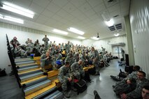 Members of the 335th Fighter Squadron wait in the Personnel Deployment Facility before deploying from Seymour Johnson Air Force Base, N.C. to Afghanistan Sept. 10, 2011. Approximately 600 Airmen from 24 career fields will leave in the upcoming weeks as part of this deployment. (U.S. Air Force photo by Senior Airman Rae Perry)