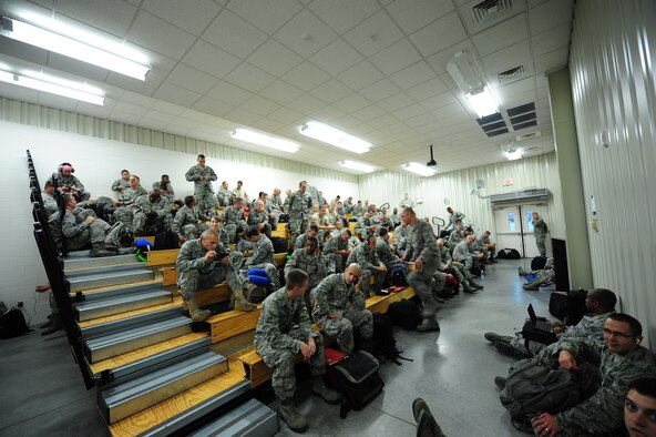 Members of the 335th Fighter Squadron wait in the Personnel Deployment Facility before deploying from Seymour Johnson Air Force Base, N.C. to Afghanistan Sept. 10, 2011. Approximately 600 Airmen from 24 career fields will leave in the upcoming weeks as part of this deployment. (U.S. Air Force photo by Senior Airman Rae Perry)