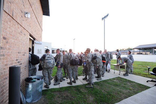 Members of the 335th Fighter Squadron wait for their turn to process through the base’s Transportation Security Administration before boarding an aircraft bound for Afghanistan at Seymour Johnson Air Force Base, N.C., Sept. 10, 2011. This marks the first six-month deployment for the squadron since the Air Force extended the traditional four-month fighter squadron deployments to six-months. (U.S. Air Force photo by Senior Airman Rae Perry)