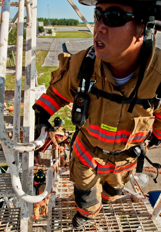 Kanoa Weza, a 96th Civil Engineer Squadron firefighter, looks up to the top of the Duke Field air traffic control tower during a 9/11 memorial stair climb at Duke Field, Sept. 11.  Thirteen firefighters commemorated the occasion by continuously climbing the steps of the ATC tower to simulate the 110-flight climb of the World Trade Center.  The firefighters hung red, white and blue streamers with the names of the 343 fallen firefighters along the tower as they climbed.  (U.S. Air Force photo/Tech. Sgt. Samuel King Jr.)