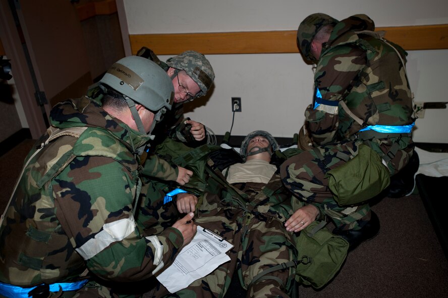Medical technicians “perform” life saving skills after a simulated chemical “attack” during an operational readiness exercise Sept. 11, 2011, McConnell Air Force Base. Kan. Airmen participated in the ORE to develop their ability to survive and operate in a contingency environment. (U.S. Air Force photo by Airman 1st Class Armando A. Schwier-Morales)
