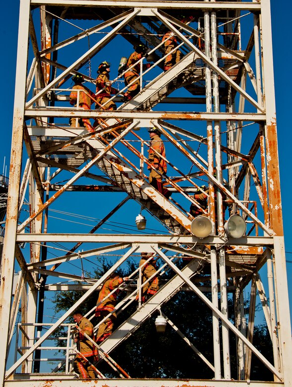 Thirteen firefighters make their way to the top of the Duke Field air traffic control tower during a 9/11 memorial stair climb at Duke Field, Sept. 11.  The firefighters commemorated the occasion by continuously climbing the steps of the ATC tower to simulate the 110-flight climb of the World Trade Center.  The firefighters hung red, white and blue streamers with the names of the 343 fallen firefighters along the tower as they climbed.  (U.S. Air Force photo/Tech. Sgt. Samuel King Jr.)