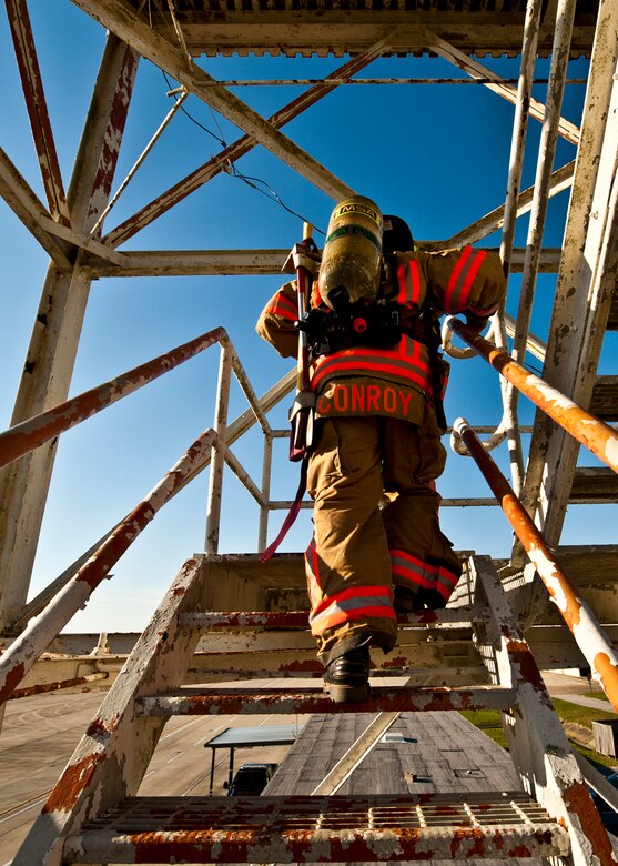 Charles Conroy, a 96th Civil Engineer Squadron firefighter, begins the climb to the top of the Duke Field air traffic control tower during a 9/11 memorial stair climb at Duke Field, Sept. 11.  Thirteen firefighters commemorated the occasion by continuously climbing the steps of the ATC tower to simulate the 110-flight climb of the World Trade Center.  The firefighters hung red, white and blue streamers with the names of the 343 fallen firefighters along the tower as they climbed.  (U.S. Air Force photo/Tech. Sgt. Samuel King Jr.)