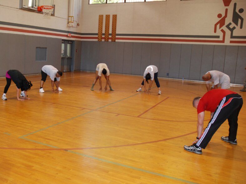 Toby Silverman, L.A. Fitness instructor, leads participants in various stretching exercises during a cardio kickboxing class at the Dobbins gym Sept.10. The fast-passed fitness class combined elements of boxing, martial arts and aerobics, providing overall physical conditioning and toning. For more information or to offer feedback or suggestions on the Dobbins fitness program, contact Master Sgt. Lena Tamplin, wing fitness manager at (678) 655-3378. (U.S. Air Force photo/Master Sgt.  James Branch)