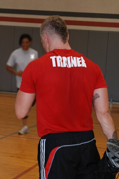 Toby Silverman, L.A. Fitness instructor, leads participants in various stretching exercises during a cardio kickboxing class at the Dobbins gym Sept.10. The fast-passed fitness class combined elements of boxing, martial arts and aerobics, providing overall physical conditioning and toning. For more information or to offer feedback or suggestions on the Dobbins fitness program, contact Master Sgt. Lena Tamplin, wing fitness manager at (678) 655-3378. (U.S. Air Force photo/Master Sgt.  James Branch)