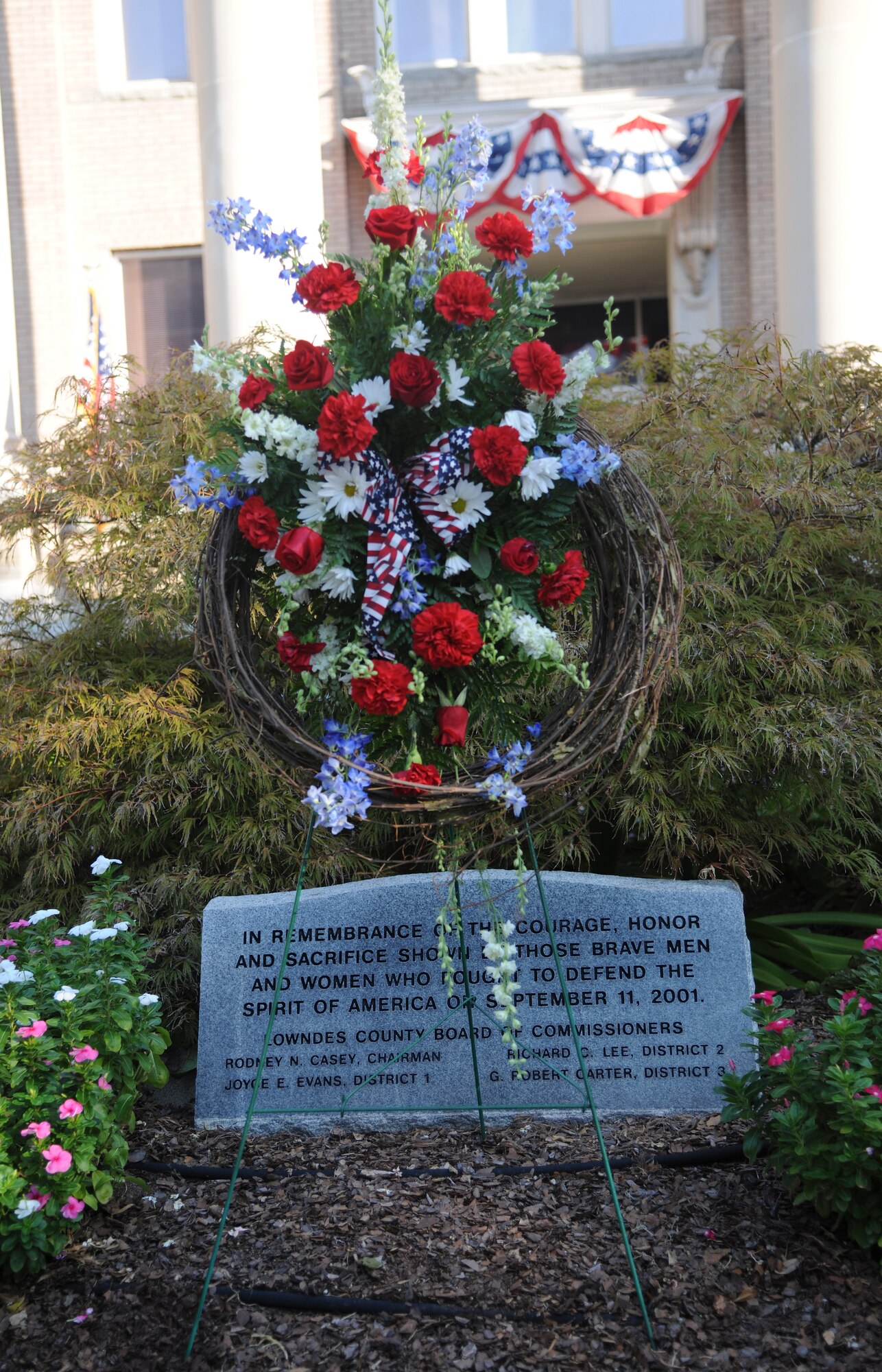A wreath and headstone is placed in front of the Valdosta Ga. courthouse on Sept 11. 2011, for the 10th anniversary of 9/11 remembrance ceremony. The headstone is dedicated to the 2,977 people who during died during 9/11, gone but never forgotten. (U.S. Air Force photo by Airman 1st Class Paul Francis/Released)
