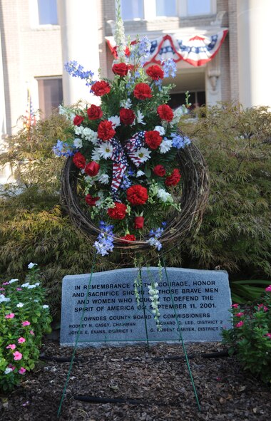A wreath and headstone is placed in front of the Valdosta Ga. courthouse on Sept 11. 2011, for the 10th anniversary of 9/11 remembrance ceremony. The headstone is dedicated to the 2,977 people who during died during 9/11, gone but never forgotten. (U.S. Air Force photo by Airman 1st Class Paul Francis/Released)
