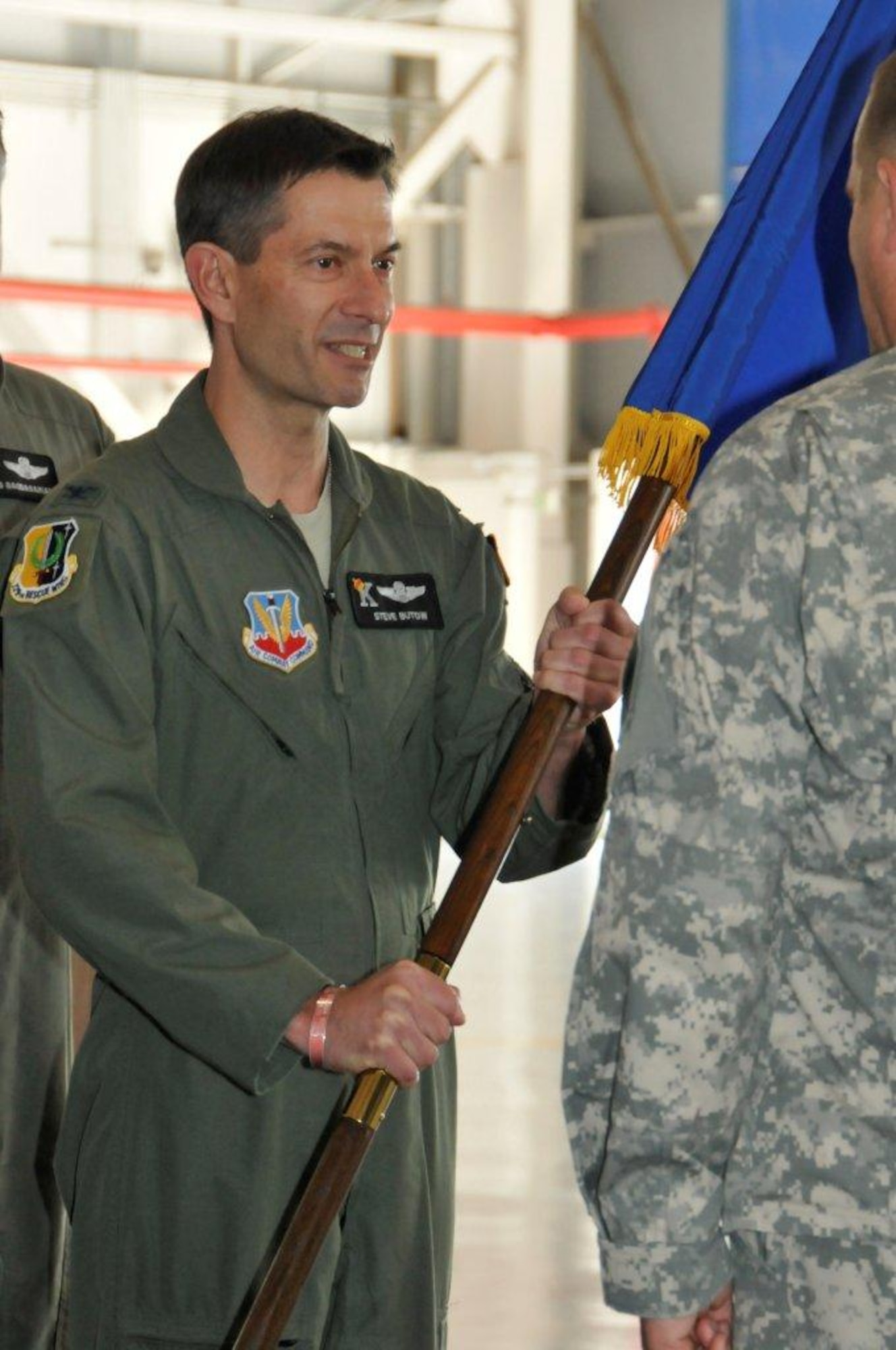 Col. Steven J. Butow, incoming 129th Rescue Wing Commander, receives the wing guidon from Maj. Gen. David S. Baldwin, The Adjutant General of the California National Guard, during the wing's change of command ceremony at Moffett Federal Airfield, Calif., Sept. 10, 2011. Butow formerly served as the wing's vice commander. (Air National Guard photo by Staff Sgt. Kim Ramirez)