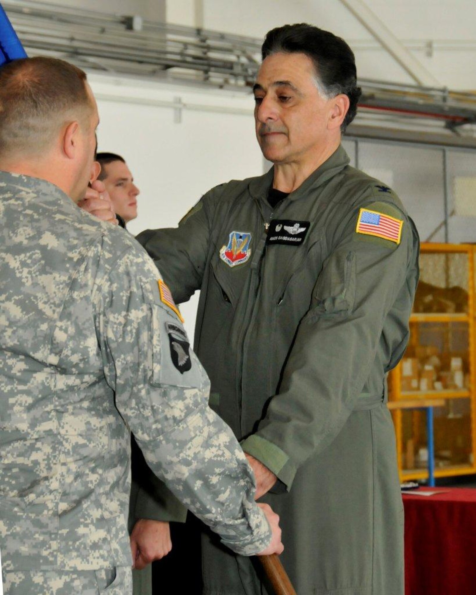 Col. Amos Bagdasarian (right), outgoing 129th Rescue Wing Commander, relinquishes the wing guidon to Maj. Gen. David S. Baldwin, The Adjutant General of the California National Guard, during the wing's change of command ceremony at Moffett Federal Airfield, Calif., Sept. 10, 2011. Bagdasarian served as 129th RQW Commander from 2005 to 2011. (Air National Guard photo by Staff Sgt. Kim Ramirez)